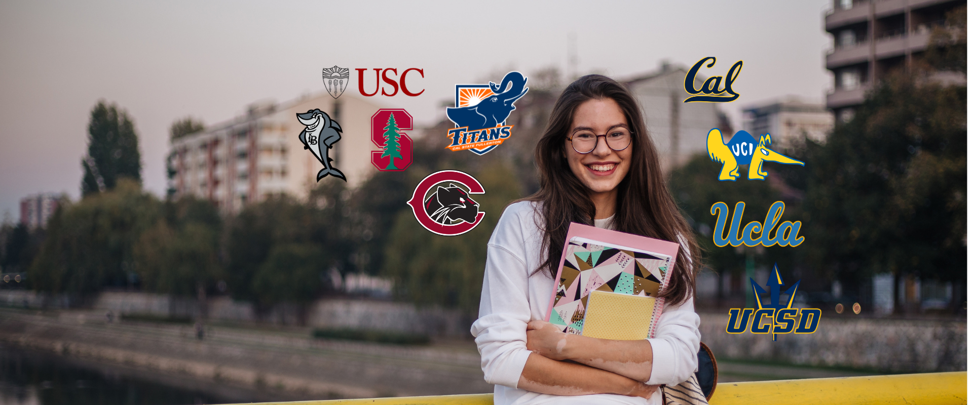 student standing on a bridge holding school books smiling various transfer school logos around her