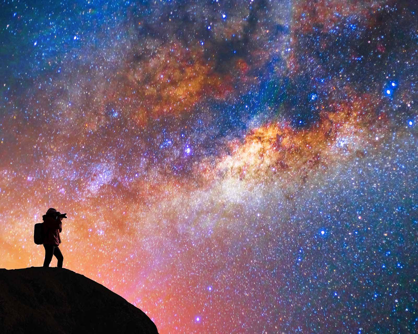 silouette of man observing the night sky