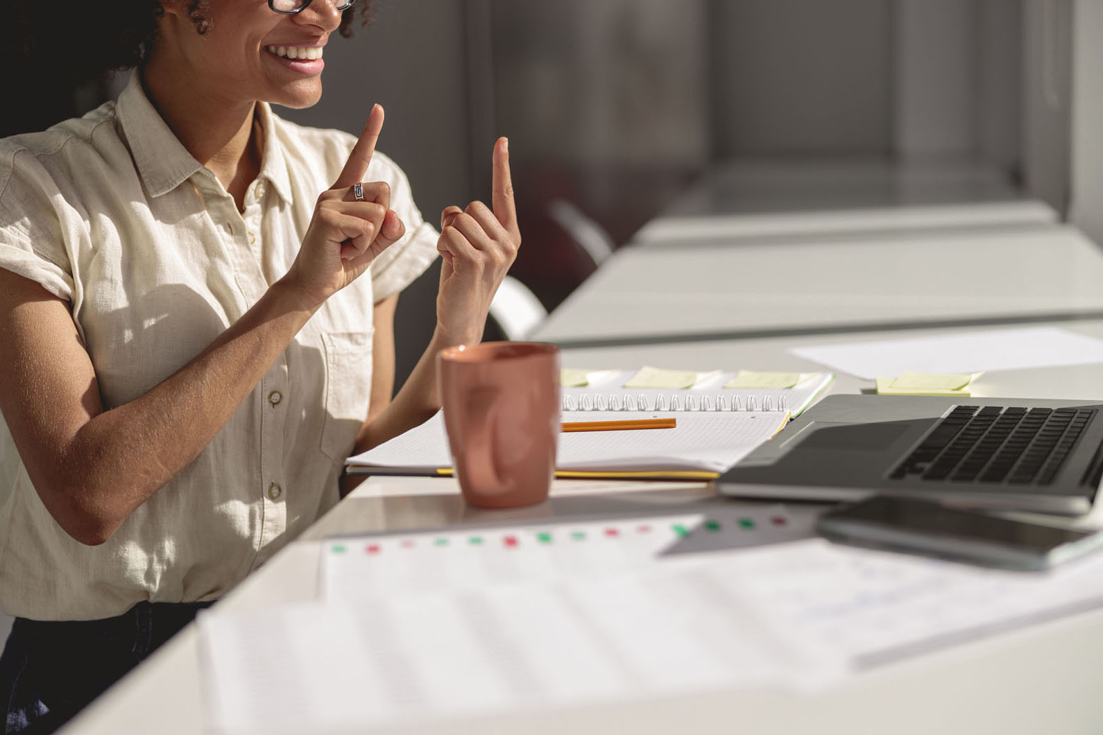 female using sign language in an office
